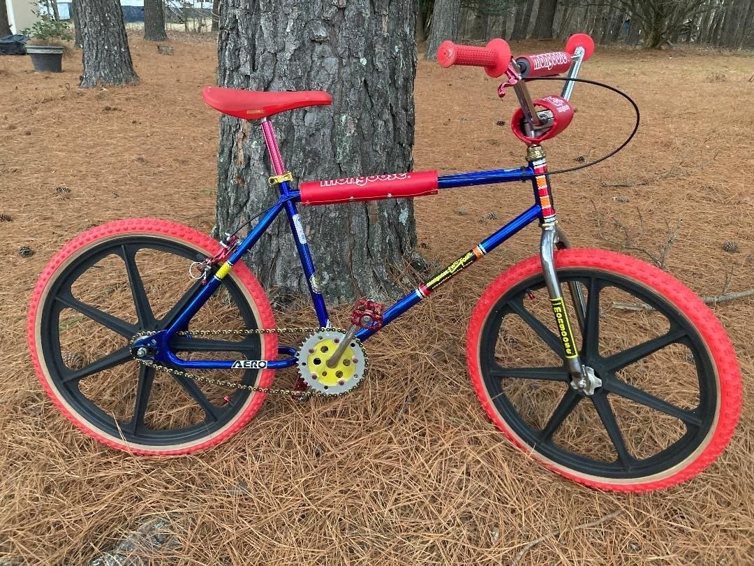 Blue BMX bike with red tires